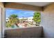 Balcony view of a community pool, tropical landscaping, and scenic outdoor living at 3301 E Earll Dr # 210, Phoenix, AZ 85018