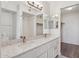 Bathroom featuring double sinks with white cabinets, granite countertops, and updated fixtures at 3301 E Earll Dr # 210, Phoenix, AZ 85018
