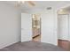 Bright bedroom features neutral carpet and a ceiling fan with attached bathroom access at 3301 E Earll Dr # 210, Phoenix, AZ 85018