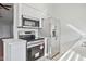 Modern kitchen featuring stainless steel appliances, white cabinets, and light countertops at 3301 E Earll Dr # 210, Phoenix, AZ 85018