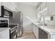 The kitchen features stainless steel appliances, light countertops, and a neutral backsplash at 3301 E Earll Dr # 210, Phoenix, AZ 85018