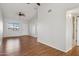 Bright, open living room with wood flooring, a ceiling fan, and neutral paint palette at 3301 E Earll Dr # 210, Phoenix, AZ 85018