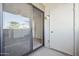 A sliding glass door opens from a carpeted bedroom onto a patio with a white storage closet and exterior door at 3301 E Earll Dr # 210, Phoenix, AZ 85018