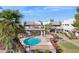 Community pool and hot tub area with lounge chairs and a covered seating area surrounded by lush landscaping at 3301 E Earll Dr # 210, Phoenix, AZ 85018