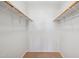Spacious walk-in closet with wood racks on both sides at 3301 E Earll Dr # 210, Phoenix, AZ 85018