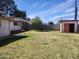 Backyard featuring shed, green grass, block wall and small tree at 3618 W Las Palmaritas Dr, Phoenix, AZ 85051
