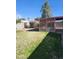 Green backyard featuring block wall, wooden gate, and covered patio at 3618 W Las Palmaritas Dr, Phoenix, AZ 85051