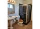 Bathroom featuring pedestal sink, toilet, and glass shower with tile base at 3618 W Las Palmaritas Dr, Phoenix, AZ 85051