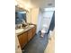 Bright bathroom featuring dual sinks, skylight, and modern tiled shower at 3637 E Monterosa St # 5, Phoenix, AZ 85018