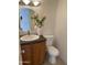 Charming powder room featuring a classic vanity and toilet, enhanced by floral accents at 3637 E Monterosa St # 5, Phoenix, AZ 85018