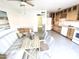 Open kitchen and dining area with updated appliances, light wood cabinets, and a cozy breakfast nook at 3637 E Monterosa St # 5, Phoenix, AZ 85018