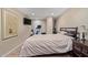 Cozy bedroom featuring a king size bed, wood floors, and a TV mounted on the wall at 36801 N Long Rifle Rd, Carefree, AZ 85377