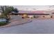 Warm desert home featuring desert landscaping, private courtyard, and red tiled roof at dusk at 36801 N Long Rifle Rd, Carefree, AZ 85377