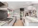 Spacious kitchen with a gourmet range, granite counters, and white cabinetry at 36801 N Long Rifle Rd, Carefree, AZ 85377