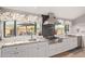 Updated kitchen showcasing a stainless steel range, granite countertops, and a pool view at 36801 N Long Rifle Rd, Carefree, AZ 85377