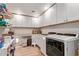 Bright laundry room features tile floors, storage cabinets, washer, and dryer at 36801 N Long Rifle Rd, Carefree, AZ 85377