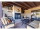 Relaxing outdoor patio with stone fireplace, tv, comfortable seating and decorative lighting at 36801 N Long Rifle Rd, Carefree, AZ 85377