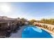 Sparkling pool surrounded by a patio, playground, and landscaped yard at 36801 N Long Rifle Rd, Carefree, AZ 85377