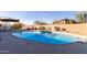 Backyard pool with lounge chairs, playset, and desert landscaping at 36801 N Long Rifle Rd, Carefree, AZ 85377