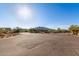 Paved street, mountain views, and desert landscaping add to the property's curb appeal at 36801 N Long Rifle Rd, Carefree, AZ 85377
