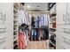 Spacious walk-in closet featuring built-in shelving, drawers, and hanging racks at 36801 N Long Rifle Rd, Carefree, AZ 85377