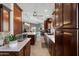 Open kitchen layout with dark wood cabinets, a center island, and modern appliances at 3689 N Crane Pl, Casa Grande, AZ 85122