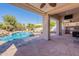 Covered patio with outdoor kitchen, ceiling fans, and views of the beautiful pool and landscaped backyard at 3820 E Carson Rd, Phoenix, AZ 85042