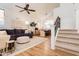 Bright living room with a ceiling fan, plush sofa, and adjacent dining area for modern living at 3825 E Irwin Ave, Mesa, AZ 85206