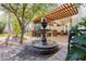 Beautiful outdoor space featuring a decorative fountain and a pergola-covered seating area at 3825 E Irwin Ave, Mesa, AZ 85206