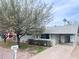 Single story home with large tree, gray exterior, covered parking and secure, fenced yard at 3934 W Windsor Ave, Phoenix, AZ 85009