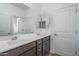 Bathroom featuring double sinks, cabinets and a large mirror with great lighting at 4022 S 178Th Ln, Goodyear, AZ 85338