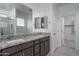 Modern bathroom featuring granite countertops, dual sinks, and a glass-enclosed shower at 4022 S 178Th Ln, Goodyear, AZ 85338