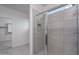 Modern bathroom featuring a walk-in shower with glass doors and neutral tile at 4022 S 178Th Ln, Goodyear, AZ 85338