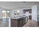 Bright kitchen featuring a large island with granite countertops, stainless steel appliances, and a view of the backyard at 4022 S 178Th Ln, Goodyear, AZ 85338
