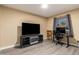 Bedroom with modern flooring, a large flat screen television and desk at 4133 W Wood Dr, Phoenix, AZ 85029