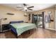 Comfortable bedroom with neutral walls, ceiling fan, and outdoor access at 4133 W Wood Dr, Phoenix, AZ 85029