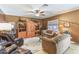 Cozy living room with neutral color walls, carpet, ceiling fan, and plush furniture at 42829 W Wild Horse Trl, Maricopa, AZ 85138