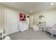 Bedroom with changing table, white doors, cute art and decorations, and a cozy armchair at 4627 E Montecito Ave, Phoenix, AZ 85018