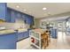 Modern kitchen featuring blue cabinets, white subway tiles, and a wooden center island with stools at 4627 E Montecito Ave, Phoenix, AZ 85018