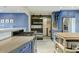 Bright kitchen featuring blue cabinets, wood accents, stainless steel appliances, and functional island at 4627 E Montecito Ave, Phoenix, AZ 85018