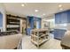 Spacious kitchen with blue cabinetry, island with seating, and a barn door leading to the laundry area at 4627 E Montecito Ave, Phoenix, AZ 85018