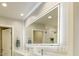 Bright bathroom showcasing dual sinks, a well lit mirror, and a glass-enclosed shower at 4627 E Montecito Ave, Phoenix, AZ 85018