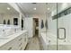 Elegant bathroom offering a double vanity, sleek tub, and a spacious walk-in closet at 4627 E Montecito Ave, Phoenix, AZ 85018