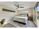Comfortable bedroom with a ceiling fan, sleek window, and access to the backyard at 4627 E Montecito Ave, Phoenix, AZ 85018