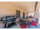 Covered back patio with a barbecue, dining set and ceiling fan at 5445 S 239Th Dr, Buckeye, AZ 85326