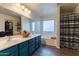 Well-lit bathroom featuring double sinks, modern vanity, soaking tub, and shower at 5445 S 239Th Dr, Buckeye, AZ 85326