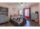 Charming bedroom features plush bedding, vintage dresser, and a ceiling fan at 5445 S 239Th Dr, Buckeye, AZ 85326