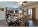 Bright dining room featuring wood-look floors, pendant lights, and direct kitchen access at 5445 S 239Th Dr, Buckeye, AZ 85326