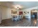 Spacious dining room featuring wood-look floors and a stylish ceiling fan at 5445 S 239Th Dr, Buckeye, AZ 85326