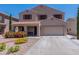 Inviting two-story home with a two-car garage and low-maintenance desert landscaping at 5445 S 239Th Dr, Buckeye, AZ 85326